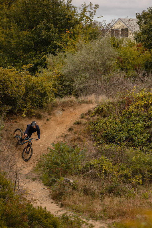 Biker airborne over a granite ledge