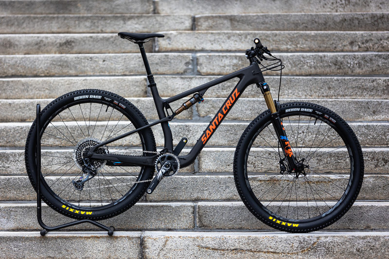 Santa Cruz Blur CC mountain bike on a repair stand against stone steps