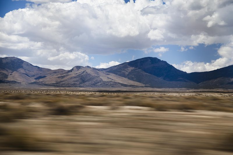 Motion-blurred desert basin and mountain range seen from a moving vehicle in Nevada