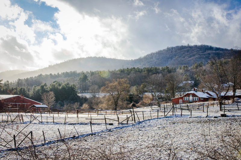 Snow-dusted farm with red barns beneath the Berkshire hills